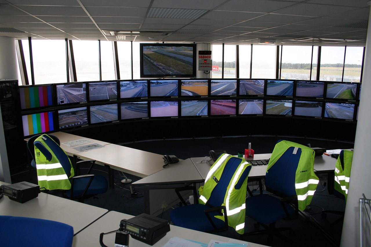 Agricultural monitoring control room with multiple screens showing surveillance feeds